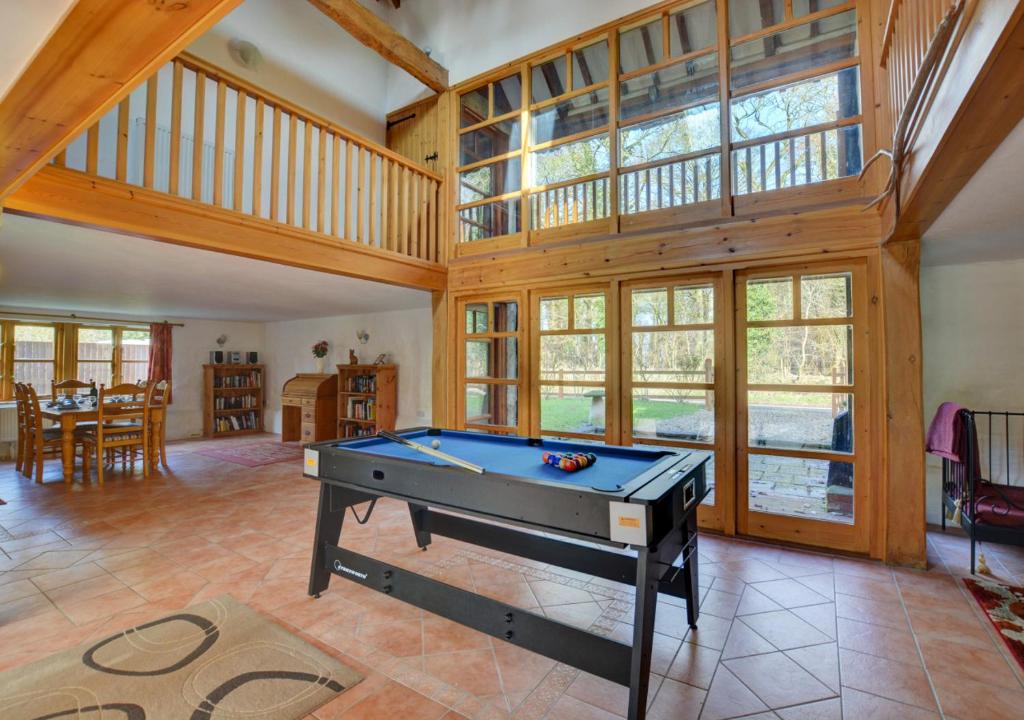 a room with a pool table in a house at Rectory Barn in Ashwellthorpe