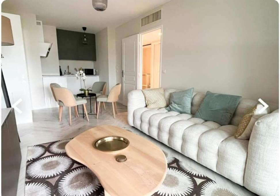 a living room with a couch and a table at beautiful apartment design next to the sea in Antibes