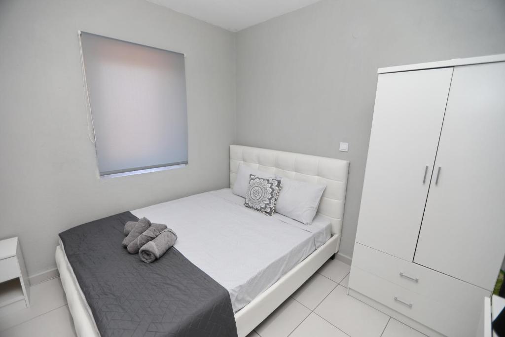 a white bedroom with a bed and a mirror at iLposto Up in Kavala