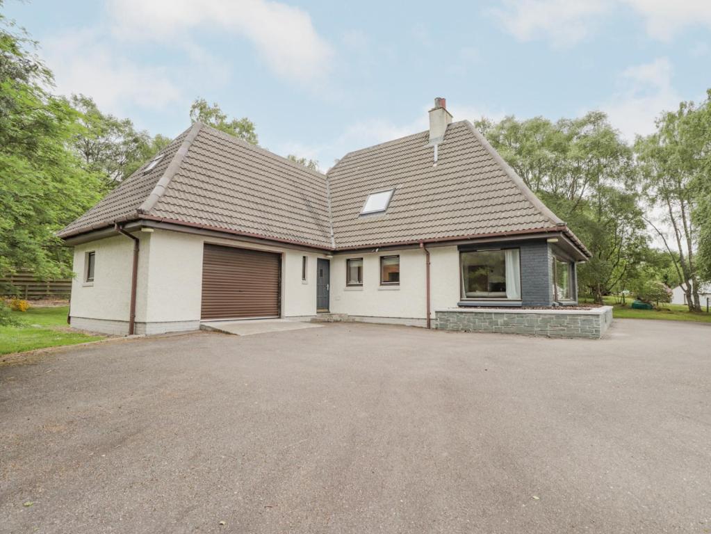 a house with a large driveway in front of it at Fresh Fields in Dingwall