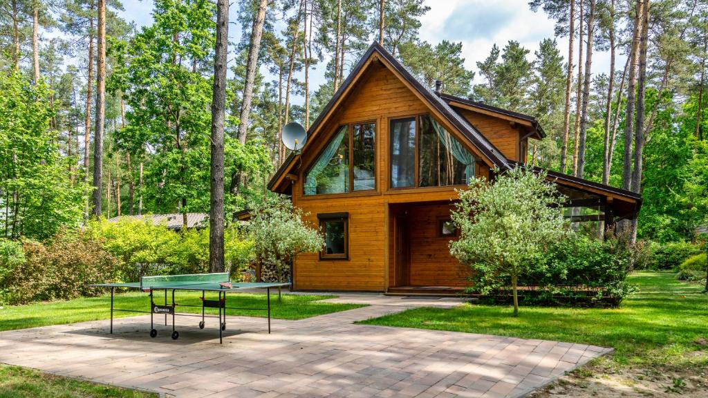 una casa con una mesa delante en Leśna Oaza, en Ostróda
