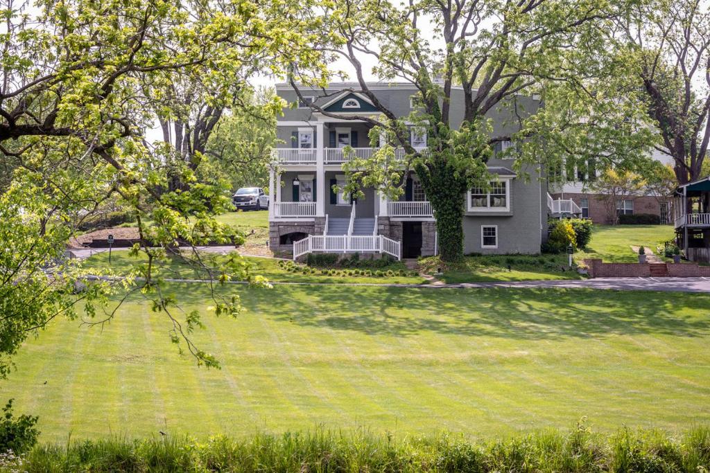 an aerial view of a house with a large yard at By the Side of the Road Inn & Cottages in Harrisonburg