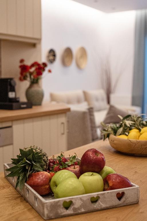 a tray of apples and other fruits on a table at Anasasmos House in Naxos Chora