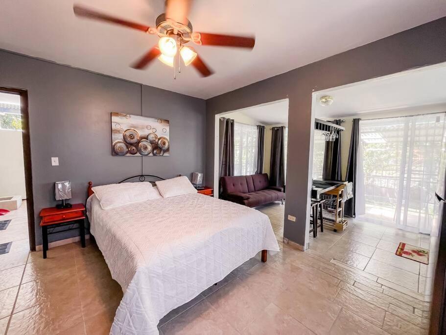a bedroom with a bed and a ceiling fan at Cozy Guest Studio Apartment in Downtown Boquete in Boquete