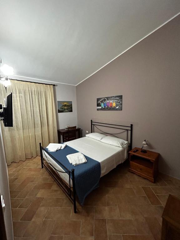 a bedroom with a bed and a table in it at Villetta Vista Mare Cornino in Custonaci