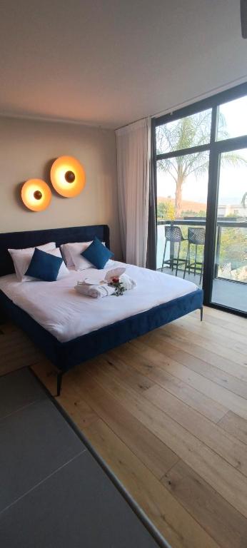 a bedroom with a bed with two lights on the wall at yoga Lake view in Had Nes