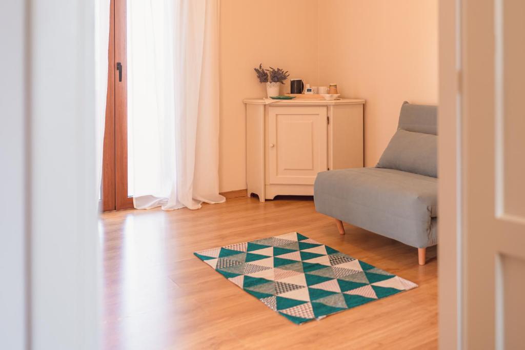 a living room with a chair and a rug at Ancóramare in Stintino