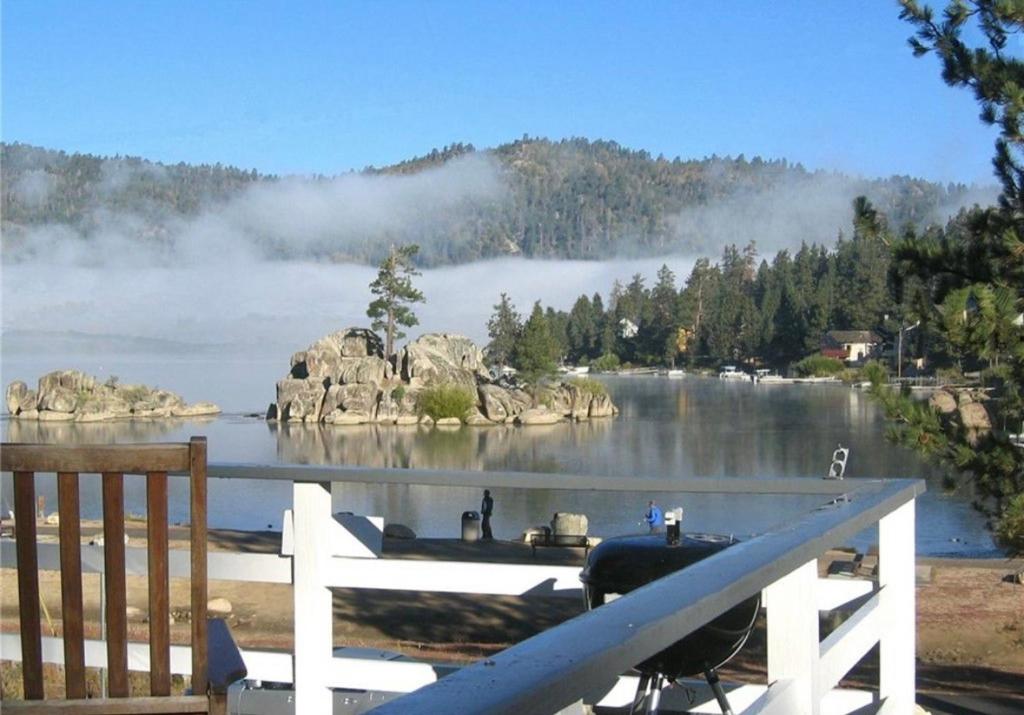 a view of a lake with a white fence at Boulder Bay Lakefront Getaway - Across the street from the lake and Boulder Bay Park! in Big Bear Lake
