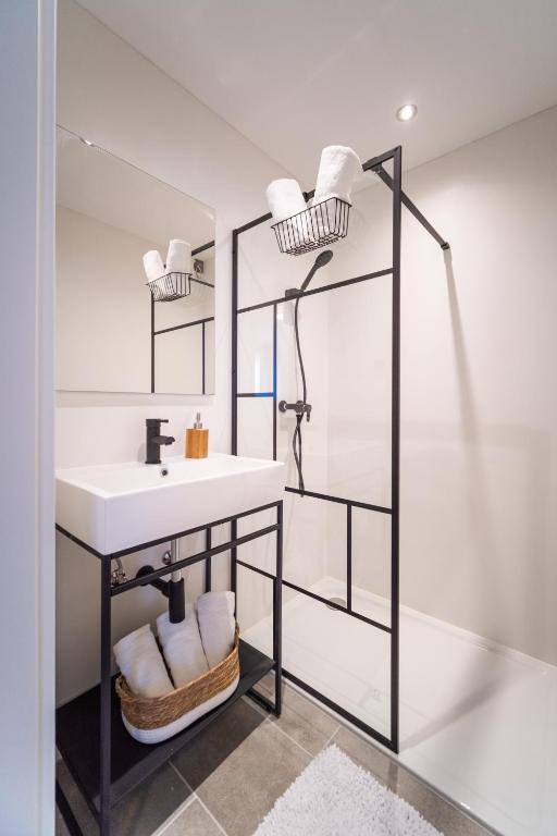 a bathroom with a sink and a mirror at Hotel Fuchs & Hase SELF CHECK IN in Rosegg