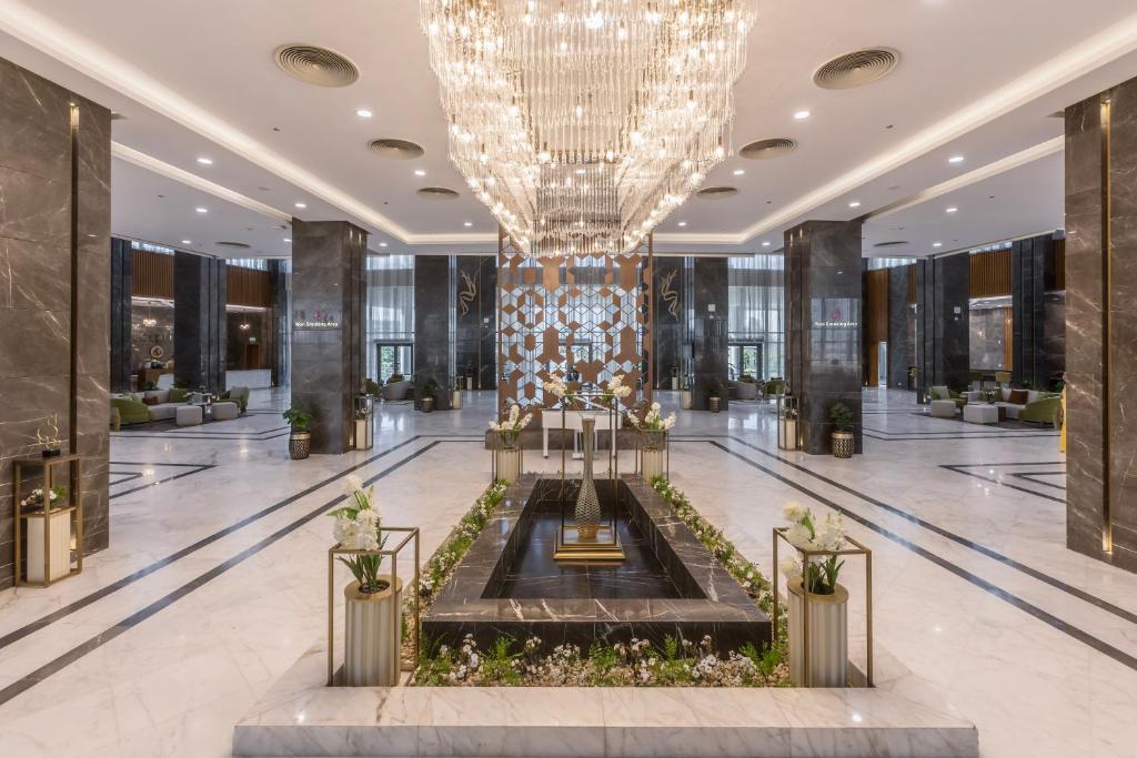 a large lobby with a chandelier in the middle at Tolip Resort Paradise New- Alamein in Marsa Matruh