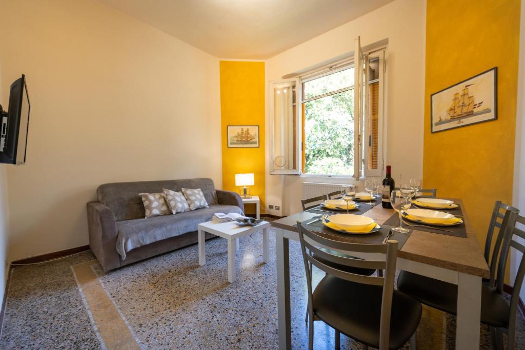 a living room with a table and a couch at Casa Pier - Centralissima in villa d'epoca in Rapallo