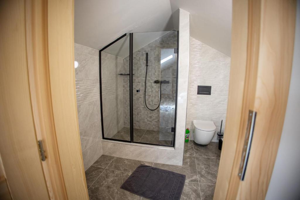 a bathroom with a shower and a toilet at Apartmán Lily in Terchová