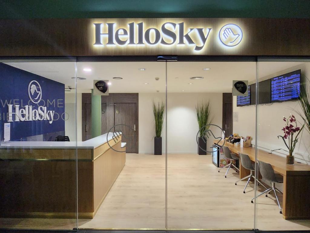 a hotel lobby with a helixasy sign on the wall at HelloSky Air Rooms Madrid in Madrid