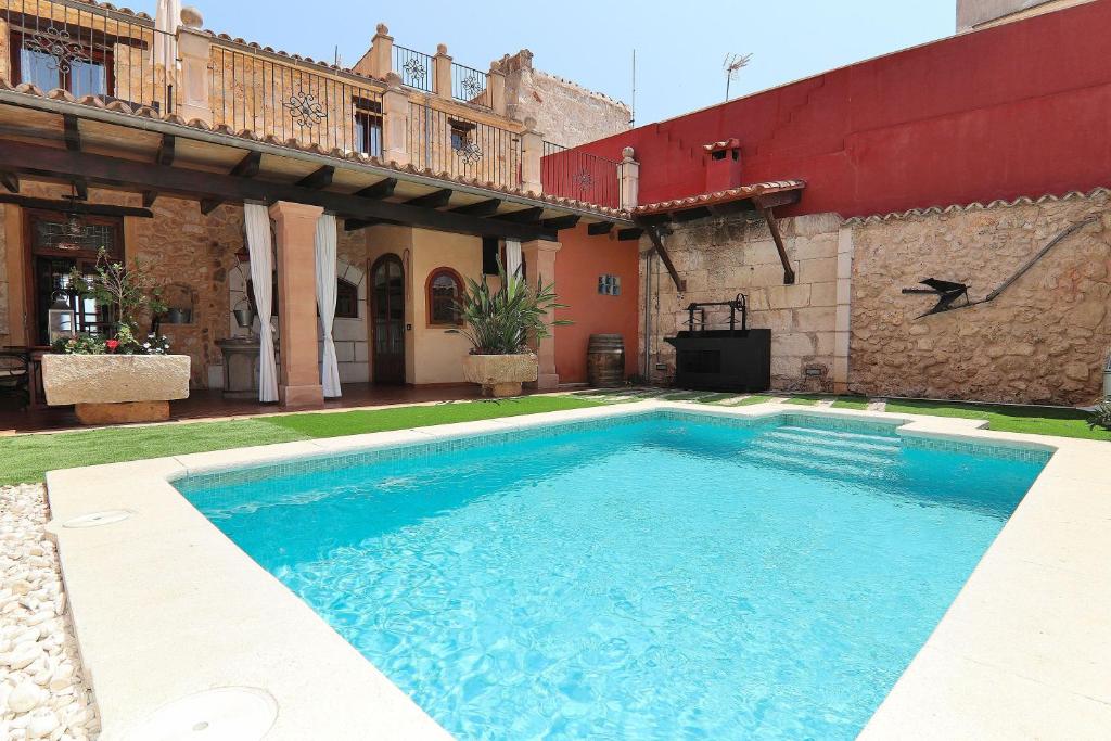 a swimming pool in the yard of a house at 243 Villa Can Bassa ETV3623 by Mallorca Charme in Muro
