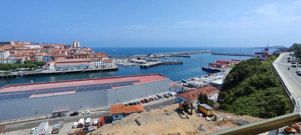 a city with a marina and a harbor with boats at Bermeo Kaia in Bermeo