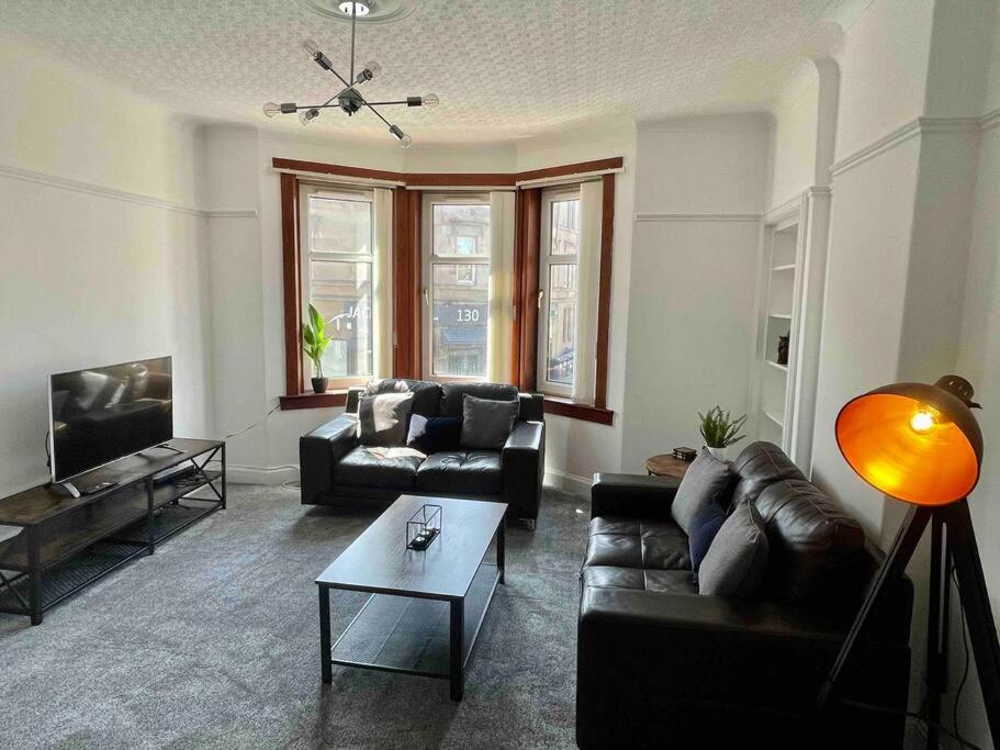 a living room with couches and a coffee table at Large 2 bed near Glasgow Airport in Paisley