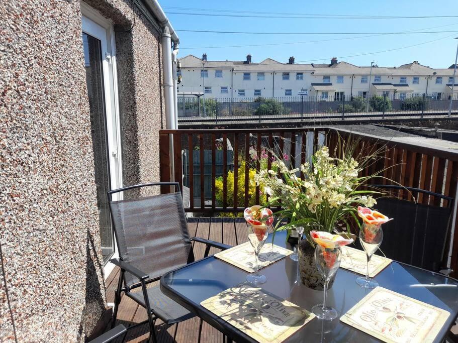 a blue table and chairs on a balcony at Plymouth Professionals Apartment in Plymouth