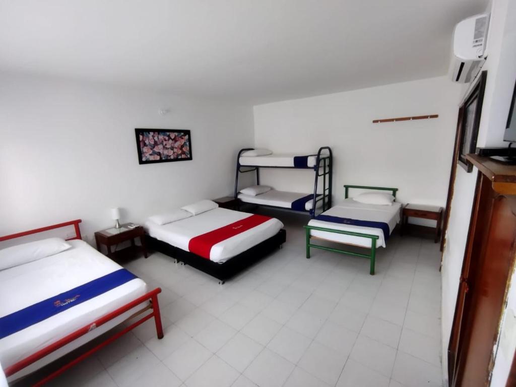 Postel nebo postele na pokoji v ubytování Hotel Villa Ricaurte