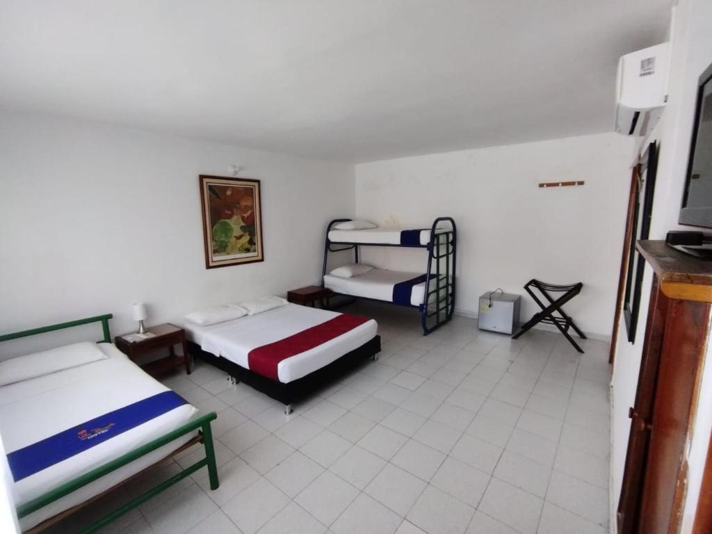 Postel nebo postele na pokoji v ubytování Hotel Villa Ricaurte