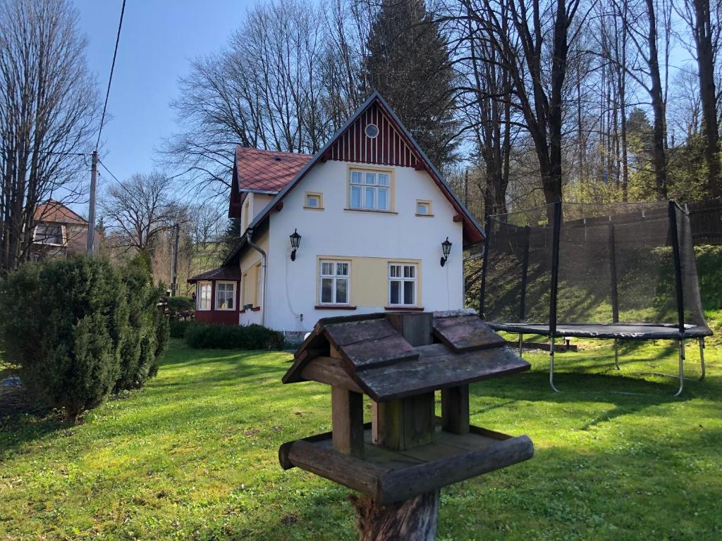 a small house with a sign in front of it at ADELLE cottage in KRKONOŠE national park in Rudník