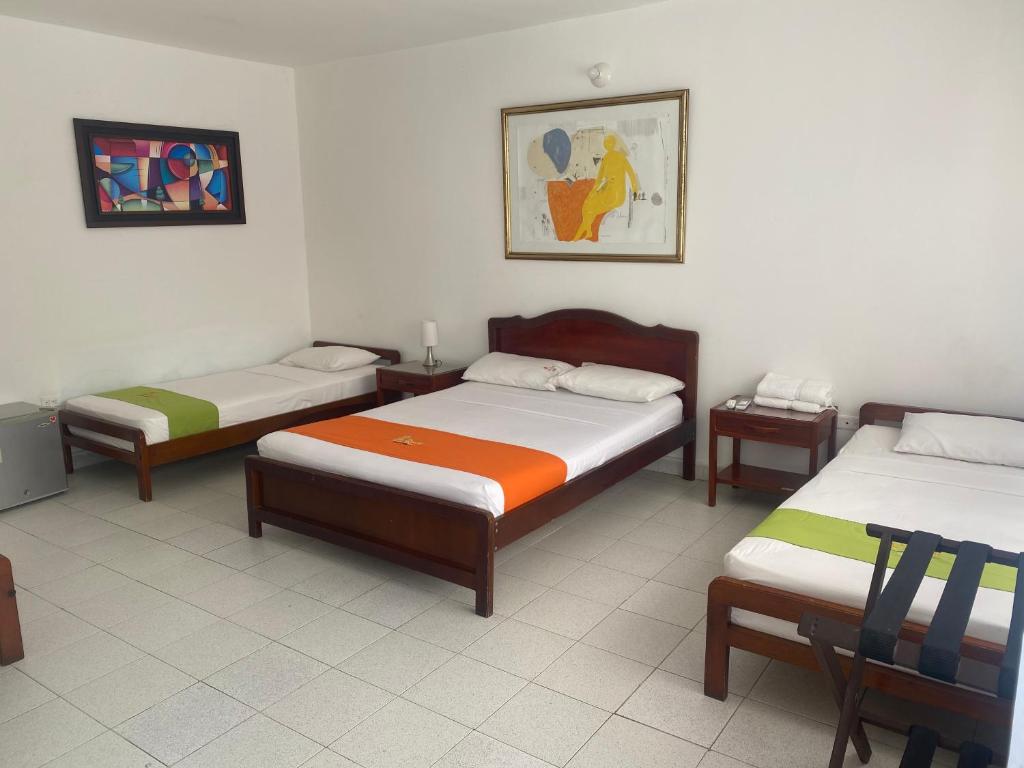 Postel nebo postele na pokoji v ubytování Hotel Villa Ricaurte