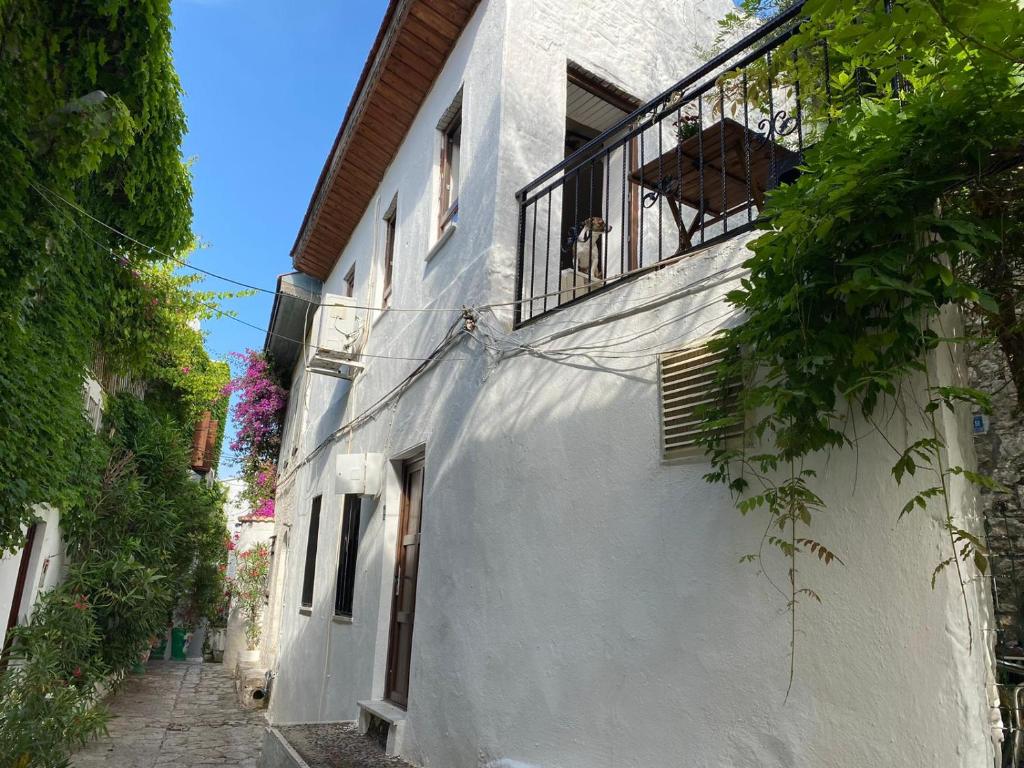 an alley with a white building with a balcony at Old town castle house-detached house in Marmaris