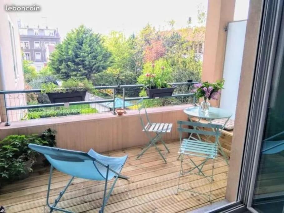 a balcony with chairs and a table on a balcony at Appartement de charme, Garage, Terrasse, Piscine in Lyon