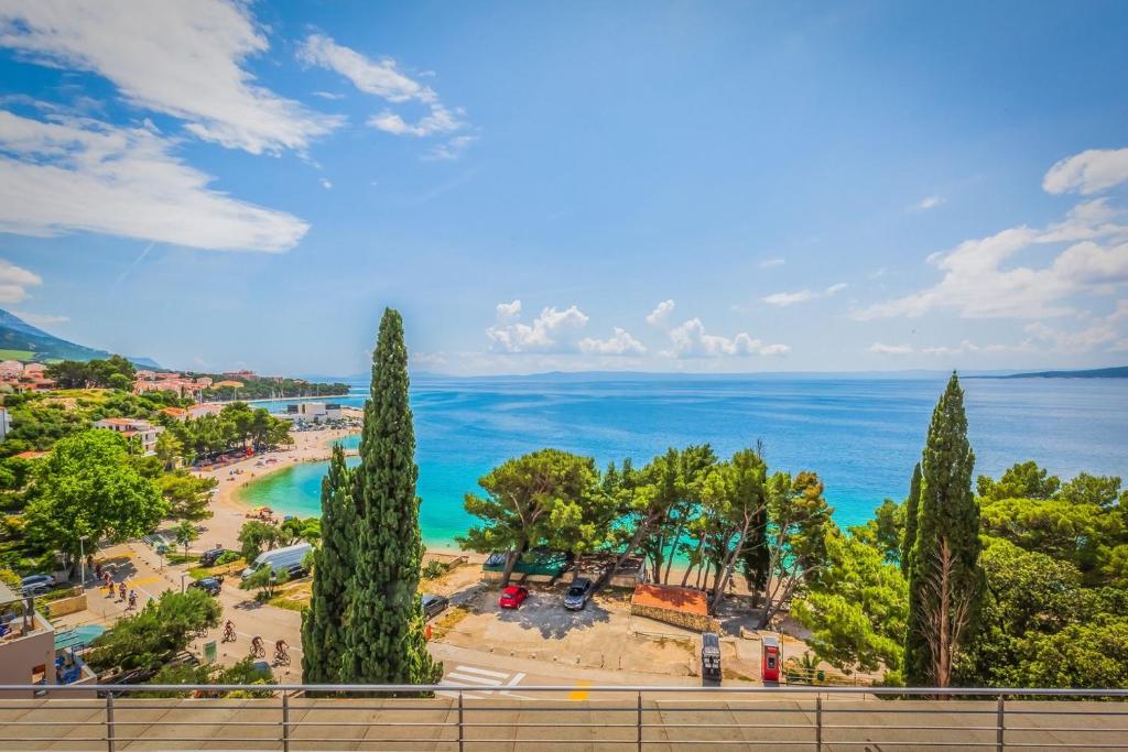 a view of a beach with trees and the ocean at Motel Ljetni raj in Baška Voda
