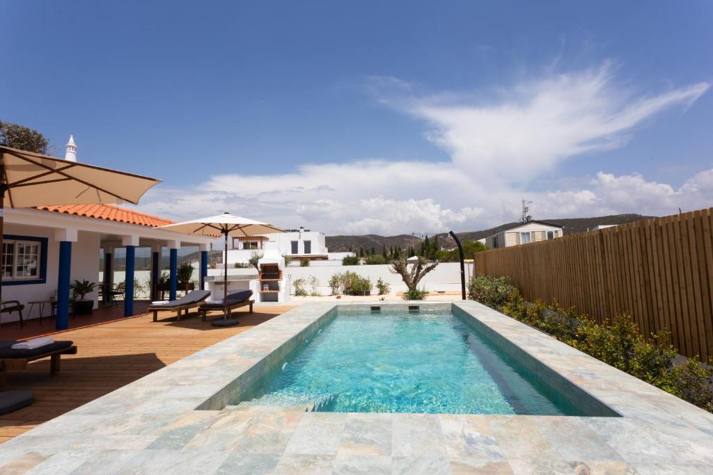 a swimming pool in the backyard of a house at Casa da praia in Carrapateira