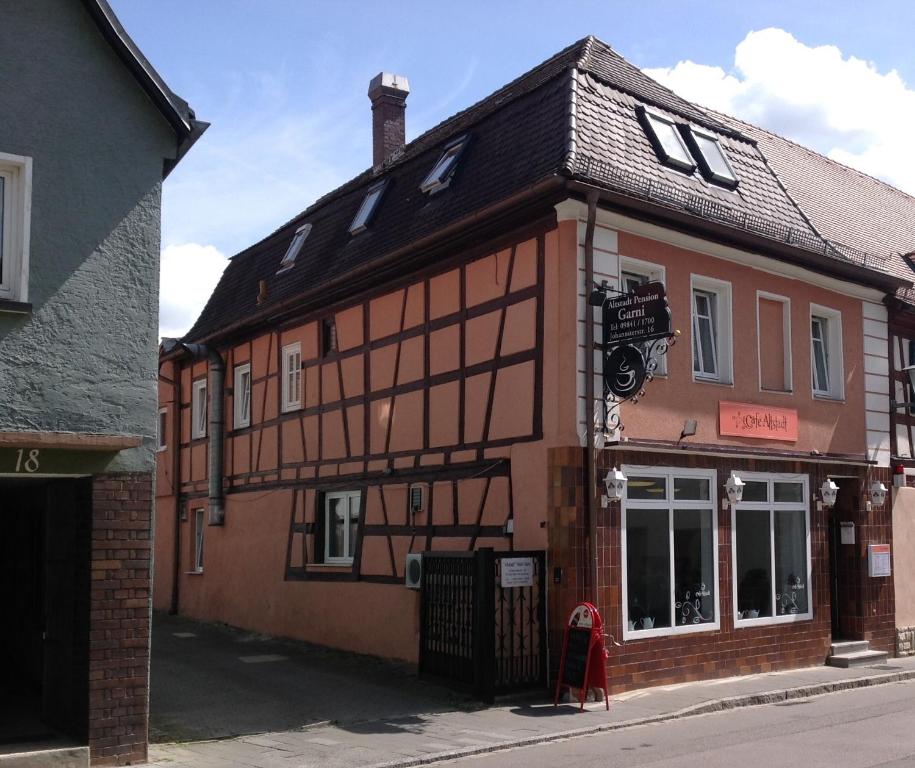 a brown building with a black roof at Pension Altstadt Garni in Bad Windsheim