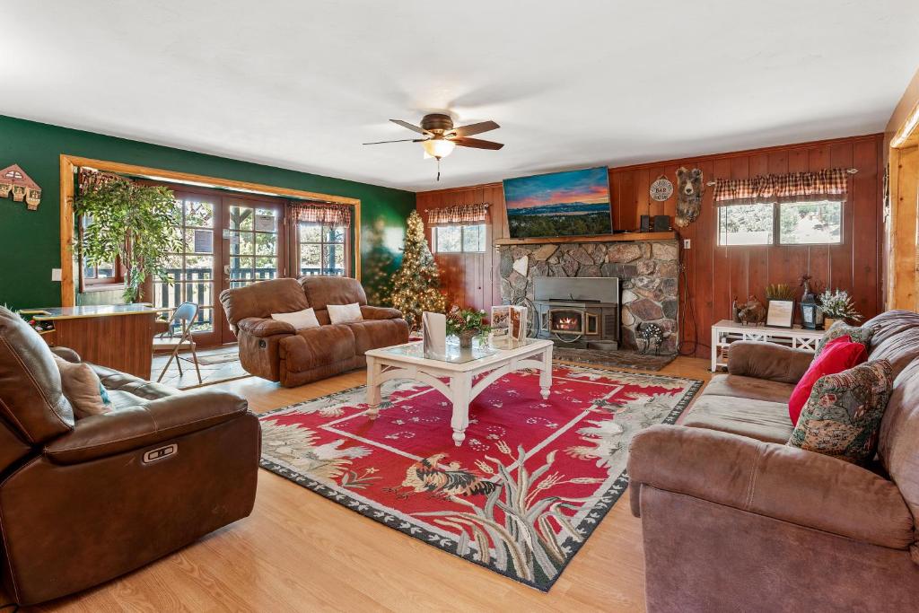 a living room filled with furniture and a fireplace at Bear family Ranch - Perfect for groups! ideal location for stargazing and sky watching! in Big Bear City