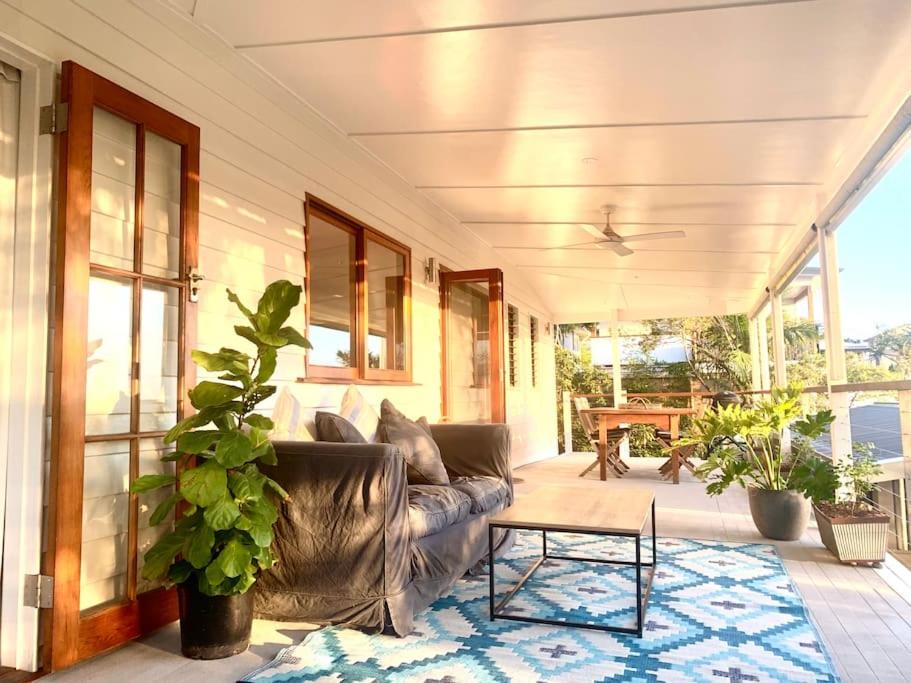 a living room with a couch and a table at Stunning Yamba Beach House! 3B+ in Yamba