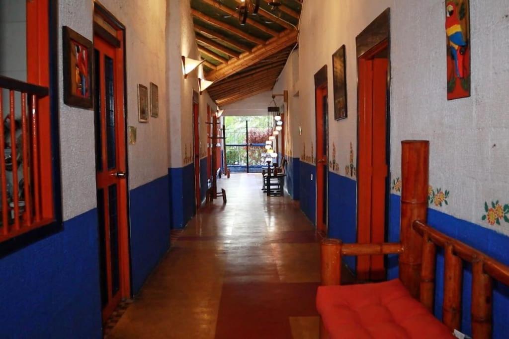 einen leeren Flur eines Gebäudes mit blauen und weißen Wänden in der Unterkunft RanchoVista coffee ring The land of Encanto in Quimbaya