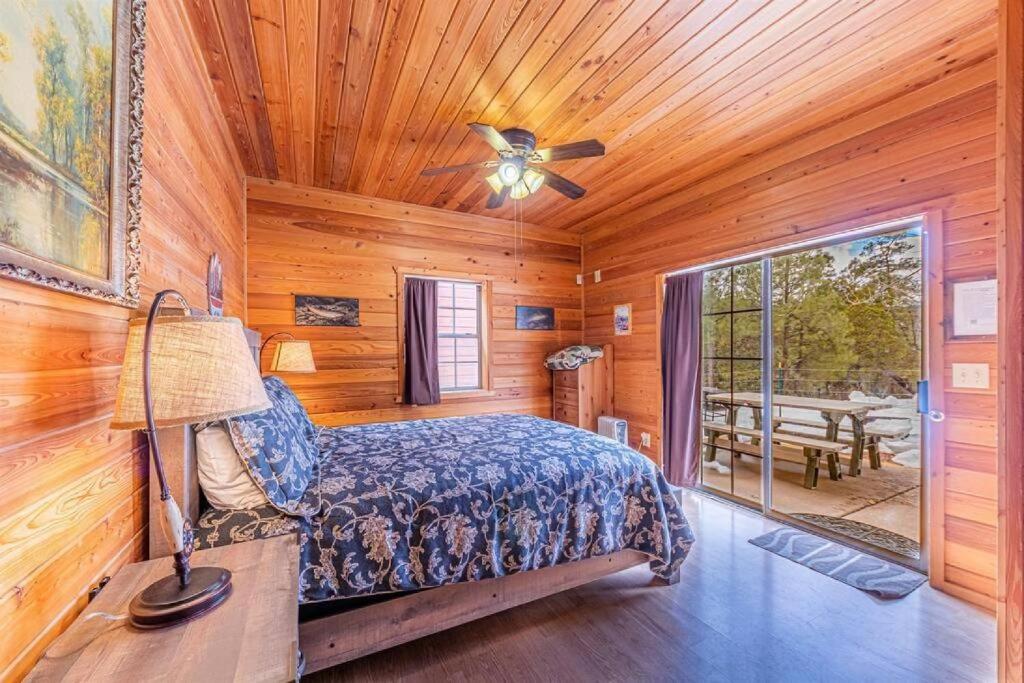 a bedroom with a bed and a ceiling fan at Cabin #5 Black Bear - Pet Friendly - Sleeps 6 - Playground & Game Room in Payson