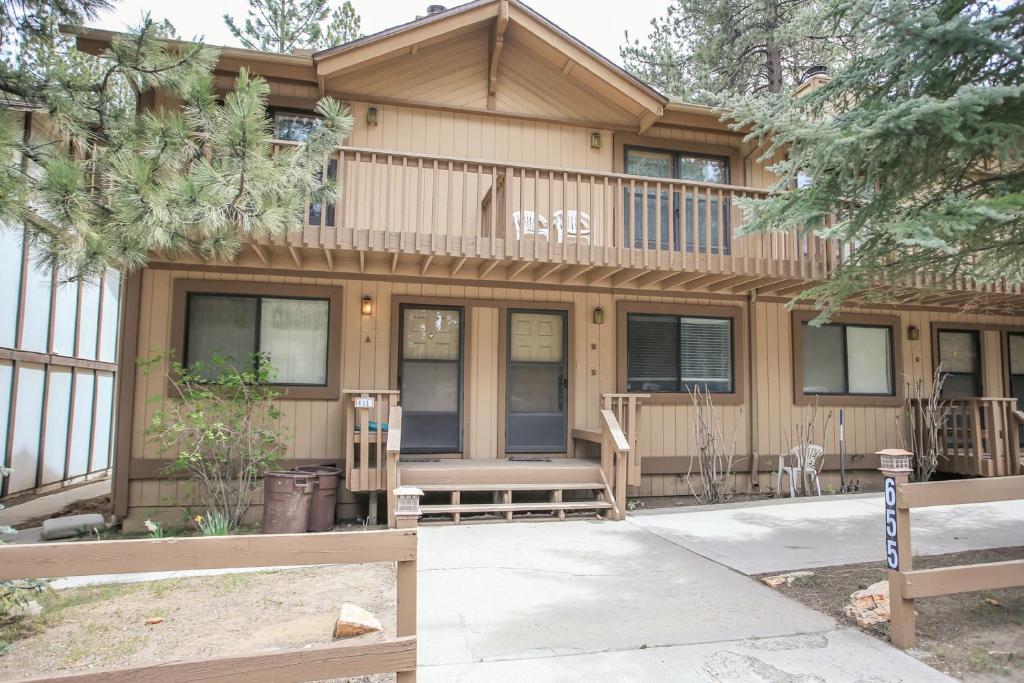 a house with a deck on the side of it at Summit Getaway Condo - Affordable and ideally located, Wood burning fireplace! Walk to Ski Resort in Big Bear Lake