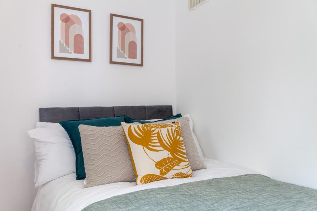 a bedroom with a bed with pillows on it at One bedroom flat in the heart of Brixton in London