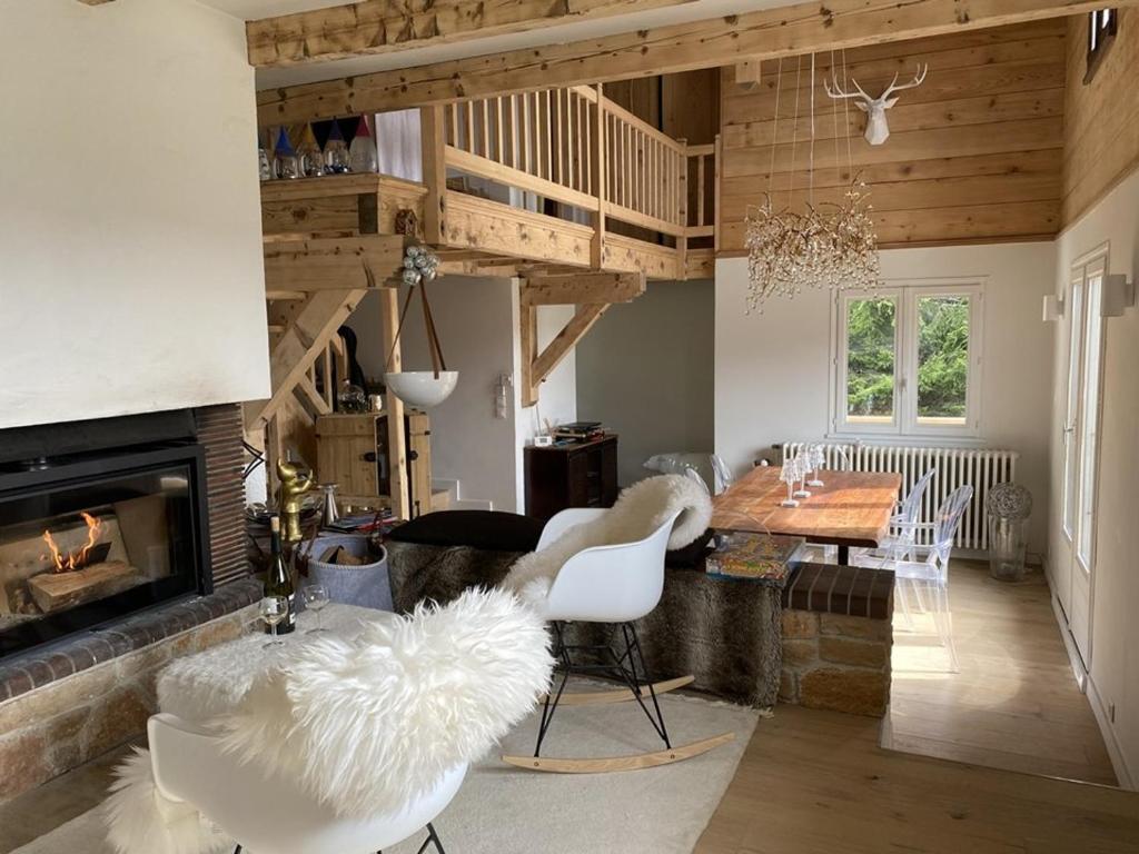 a living room with a fireplace and a table and chairs at Chalet Crest-Voland, 6 pièces, 10 personnes - FR-1-733-70 in Crest-Voland