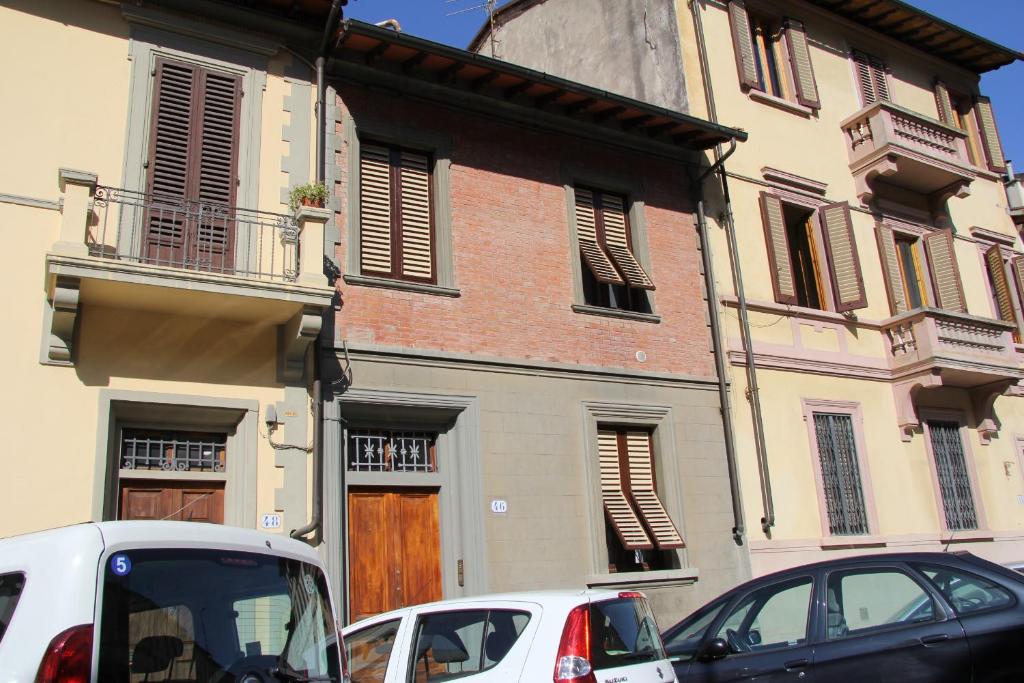 two cars parked in front of a building at Burchiello b&b in Florence