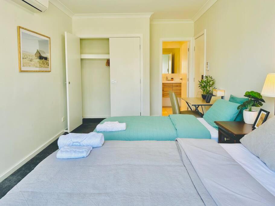 a living room with a bed and a couch at 8 Beds l 4 Suites with Office l Austral3 in Austral
