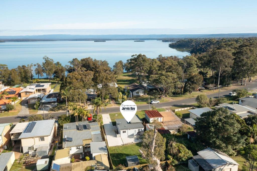 an aerial view of a town with houses and a lake at Wanderer by Experience Jervis Bay in Sanctuary Point