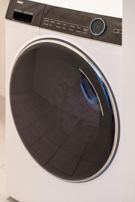 eine weiße Waschmaschine mit offener Tür in der Unterkunft Whats-App Self-Check-IN - 1BR Apartment, near airport,15 min to Center in Wien