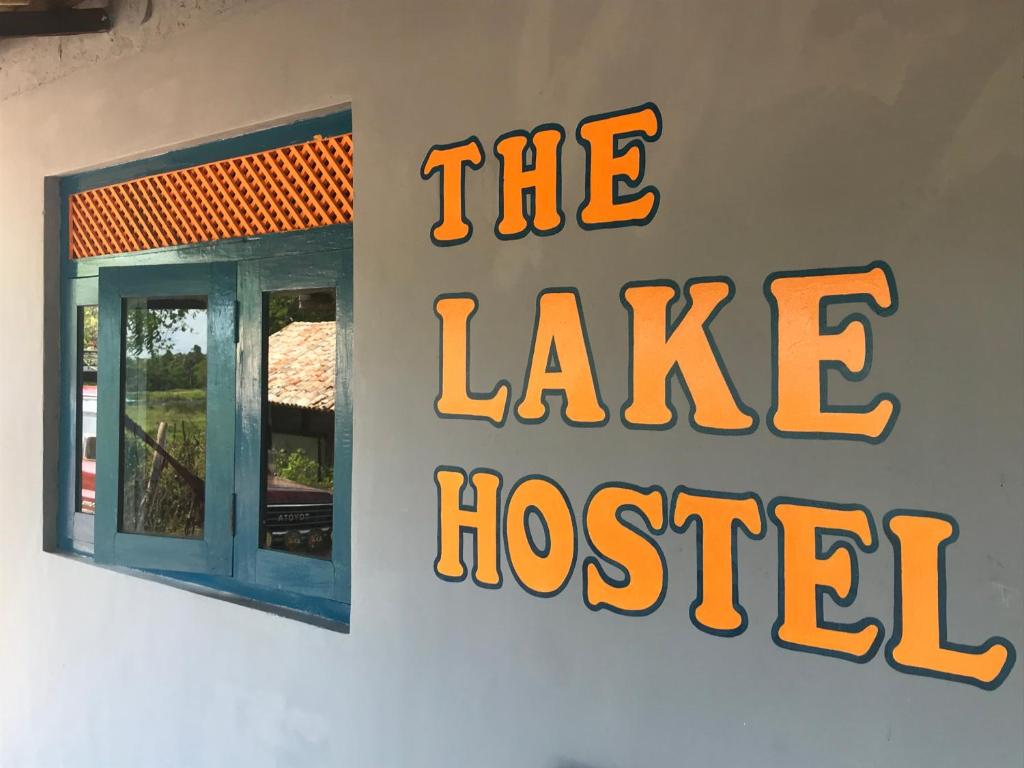 a sign for the lake hotel on the side of a building at The Lake Hostel - with views over Habarana Lake in Habarana