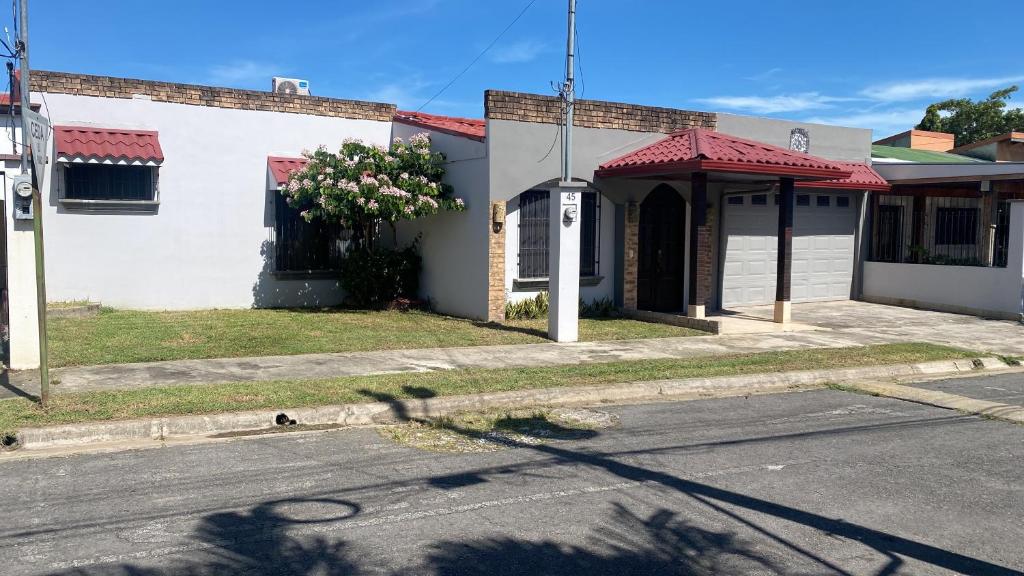 an empty street in front of a white building at Casa Camino Luna Private Rooms in Liberia