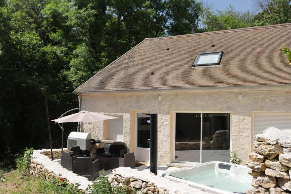 a house with a hot tub in front of it at Gîte aux trois suites parentales et son jacuzzi 