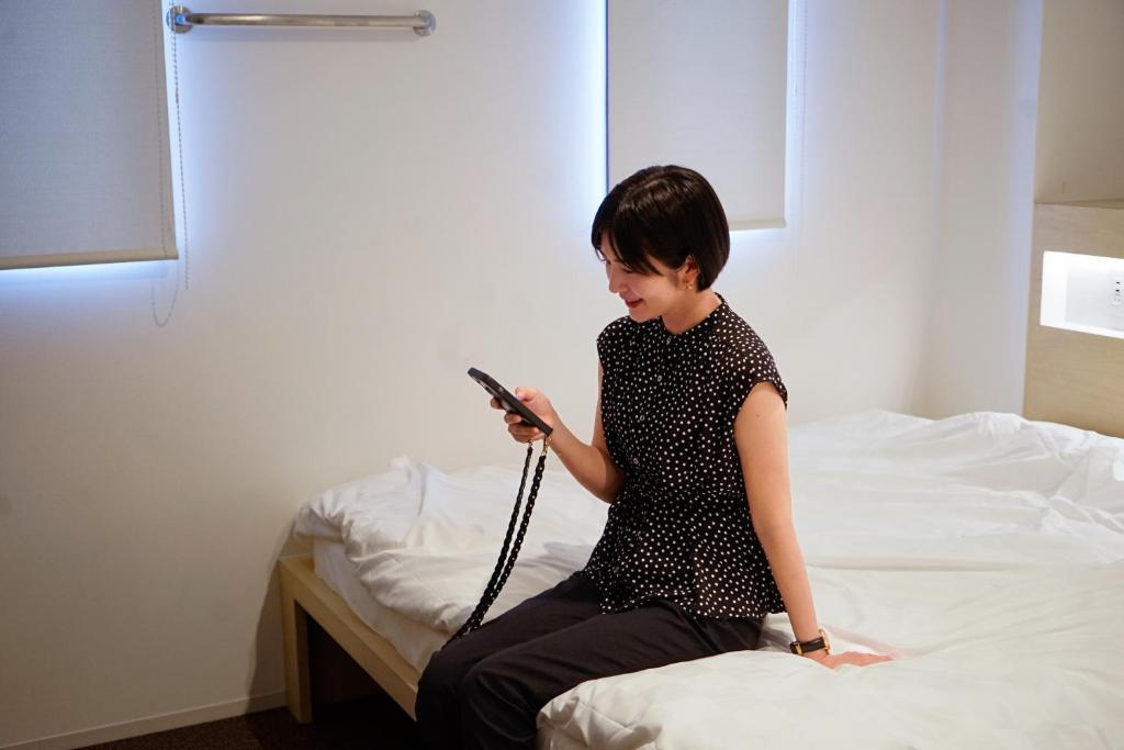 Postel nebo postele na pokoji v ubytování WeBase Kyoto