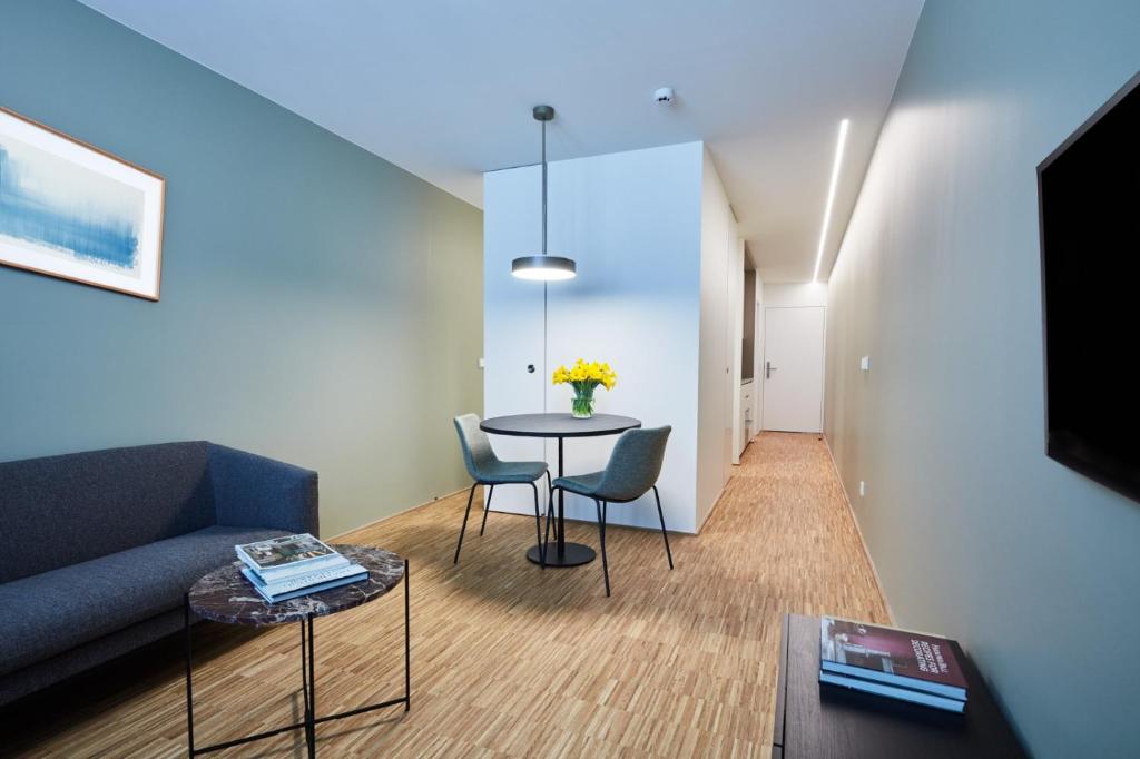 a living room with a couch and a table at Résidence du Lys - Perrin Apartments in Luxembourg