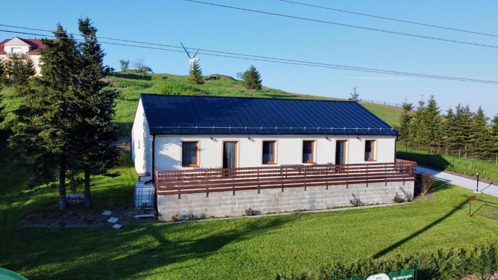 a small house with a blue roof on a hill at Jachovka in Nová Ves v Horách