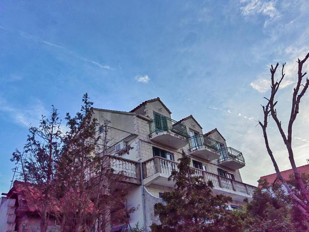 a building with balconies on the side of it at Apartments Vejo in Korčula