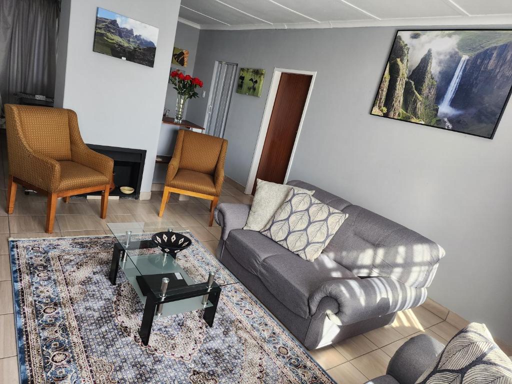 a living room with a couch and a table at Motebong Villa in Maseru