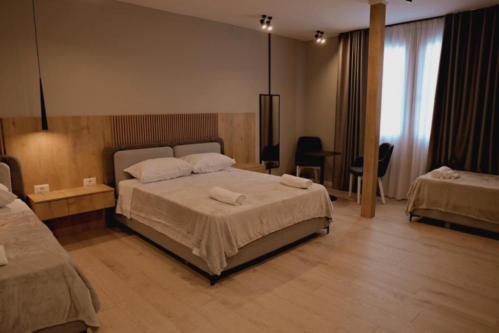 a bedroom with a bed with two towels on it at Sol Hotel in Shkodër